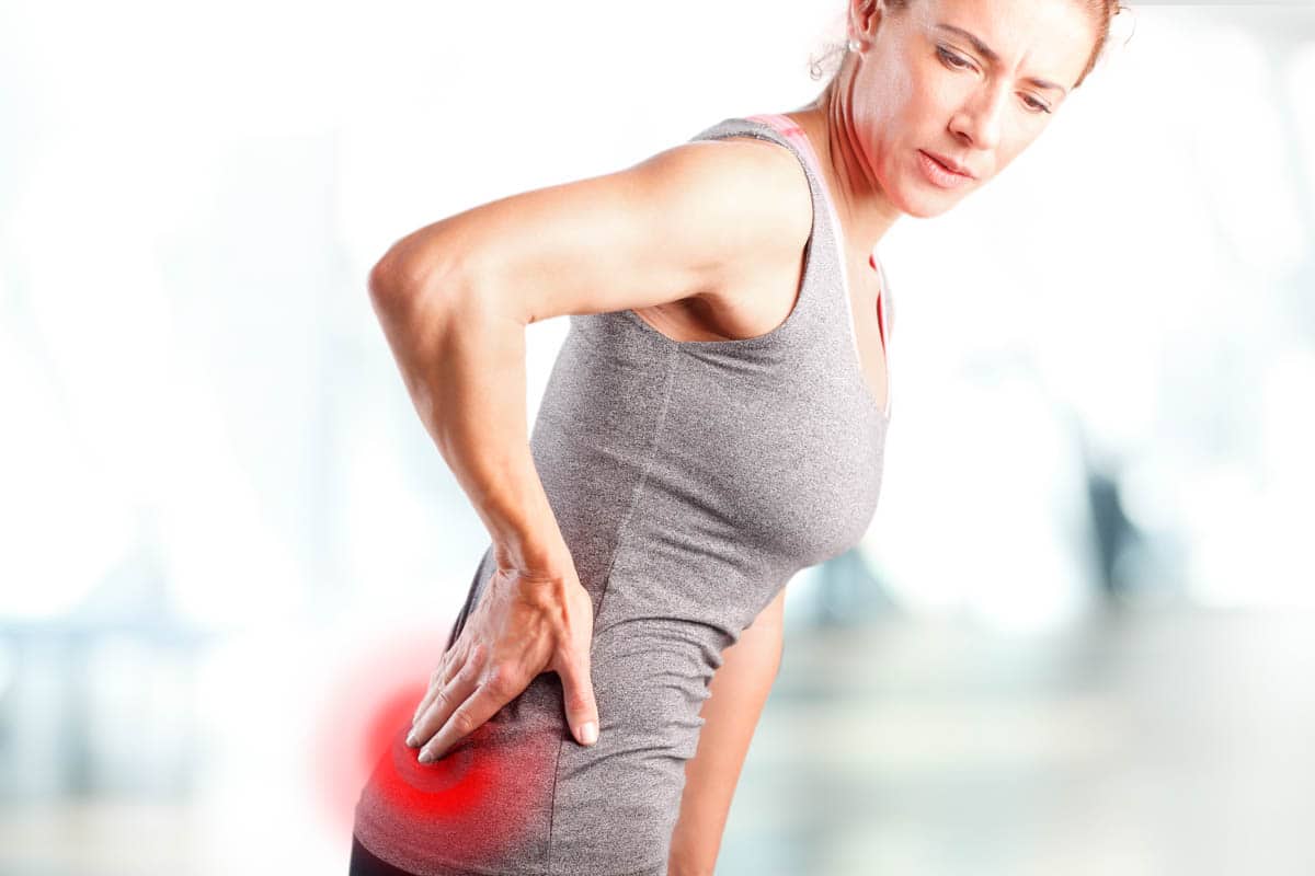 Ischiasbeschwerden Definition – Frau mit Rückenbeschmerzen